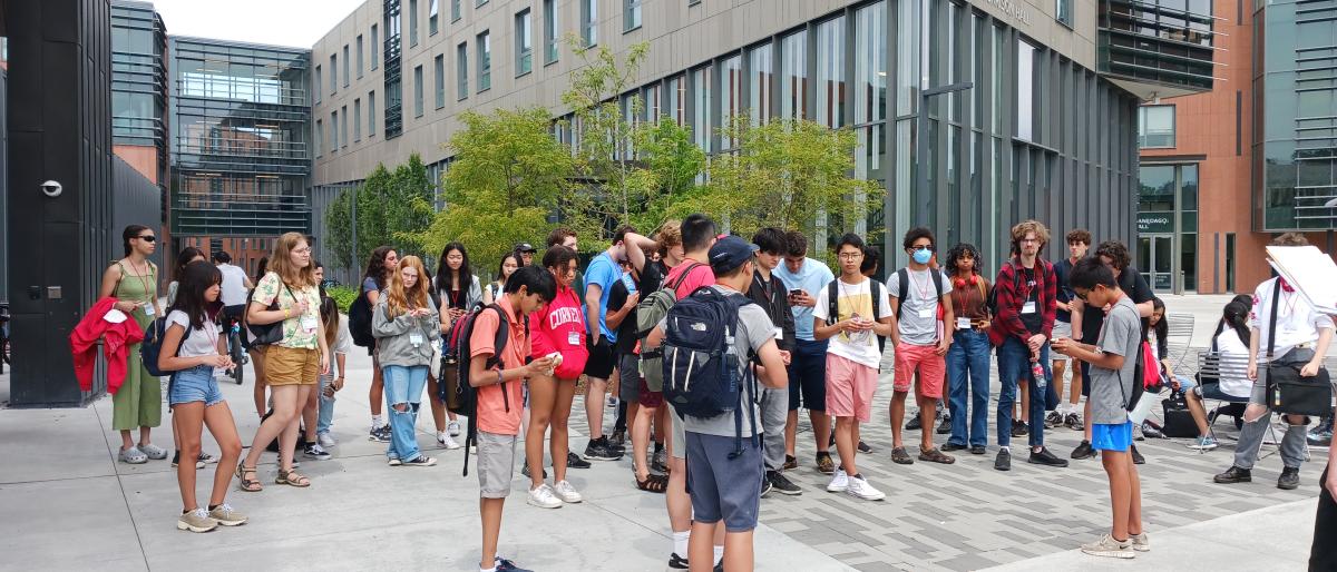 a large group of students stand outside